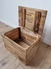 A wooden chest with its lid open, placed on a wooden floor against a white wall. Náhled obrázku produktu