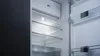 An empty refrigerator with its door open, showing the interior shelves and compartments. Produktbild-Vorschau