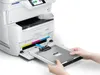 Hands inserting a tray into a printer. Voir les images du produit