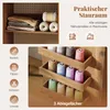 A sewing table with storage compartments filled with spools of thread and fabric. Produktbild-Vorschau