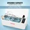 A white ultrasonic cleaner filled with water, containing glasses, a watch, and a makeup brush. Voir les images du produit