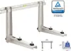A set of silver wall mounts for an air conditioner unit, shown from a diagonal angle. The mounts are made of metal and have adjustable feet. A spirit level is integrated into the top bar. There is also a TÜV Rheinland Certified logo in the upper right corn Produktbild-Vorschau