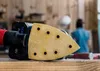 Close-up of a sander pad with a person blurred in the background. Produktbild-Vorschau