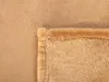A close-up view of a folded blanket, showing the texture of the fabric and the hem. Podgląd zdjęcia produktu