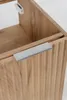 A close-up view of a wooden cabinet with a ribbed texture and a silver handle. Anteprima dell’immagine prodotto