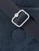 A close-up shot of a dark blue Kipling crossbody bag, focusing on the strap and a circular brand logo. Produktbild-Vorschau