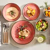 A table setting with multiple plates of food, cutlery, and a fruit salad. Náhled obrázku produktu