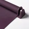 A close-up of a purple roller blind, showing the fabric and the mounting bracket. Produktbild-Vorschau
