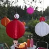 Outdoor setting with lanterns hanging from trees and a table with drinks and candles. Podgląd zdjęcia produktu