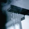 Close-up of a shower head with water and steam. Produktbild-Vorschau
