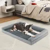 A dog is lying on a dog bed in a bedroom next to a bed. Voir les images du produit