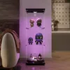 A modern living room with a display cabinet filled with collectibles, illuminated by purple LED lights. Produktbild-Vorschau