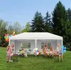 A family is enjoying a barbecue and gathering under a white party tent in a grassy backyard. Náhled obrázku produktu