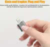 A hand holding a small silver adapter with a lightning connector. Produktbild-Vorschau