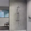 A modern bathroom shower system mounted on a textured gray wall, with a reflection of another part of the bathroom visible on the left. Podgląd zdjęcia produktu