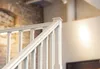 A close-up view of a white wooden staircase railing. Produktbild-Vorschau