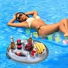 A woman is relaxing on an inflatable mattress in a swimming pool, with an inflatable tray floating nearby containing drinks and fruit. Náhled obrázku produktu