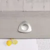 A close-up of a grey curtain with a triangular metal eyelet and two lemon slices on a white surface with text. Produktbild-Vorschau