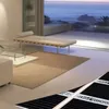 A modern living room with a view of the ocean. Produktbild-Vorschau