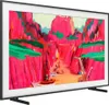 A Samsung Frame TV displaying a vibrant, colorful artwork of a canyon scene with people and boats. Produktbild-Vorschau