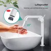 A white faucet is shown in use, with water flowing into a white sink. A close-up inset shows the aerator of the faucet. Podgląd zdjęcia produktu