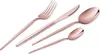 A set of rose gold cutlery, including a fork, knife, and two spoons, arranged diagonally on a white background. Anteprima dell’immagine prodotto