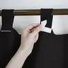 A hand is shown attaching a black curtain to a curtain rod using velcro straps. Anteprima dell’immagine prodotto