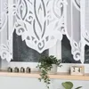 A close-up of a white lace curtain hanging over a window, with decorative wooden blocks spelling 'HOME' and a potted plant on the windowsill. Anteprima dell’immagine prodotto