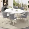 A dining set with a white oval table and six gray chairs, placed on a circular rug in a well-lit room with a large window overlooking a garden. Produktbild-Vorschau