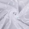 A close-up, swirled view of white sheer fabric with embroidered scroll patterns. Produktbild-Vorschau