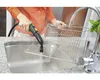A person is using a steam cleaner to clean a metal rack in a kitchen sink. Anteprima dell’immagine prodotto