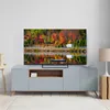 A modern living room with a TV displaying a scenic autumn landscape. Anteprima dell’immagine prodotto