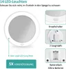 A product image showing a makeup mirror with LED lights and its features, including a button switch, suction cups, and a battery compartment. Produktbild-Vorschau