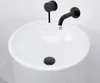 A close-up view of a white sink with black fixtures. Anteprima dell’immagine prodotto
