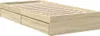 A wooden bed frame with two drawers underneath, shown from a side angle. Produktbild-Vorschau