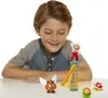 A young boy is looking at a Super Mario toy set on a table. Produktbild-Vorschau