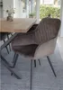 A dining chair next to a wooden dining table in a well-lit room. Voir les images du produit