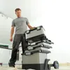 A man is stacking toolboxes in a room. Voir les images du produit