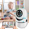 A baby playing with toys in a room, with a security camera and a smartphone displaying the camera's feed. Anteprima dell’immagine prodotto
