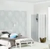 A bedroom setting with a bed, pillows, a bench, and a decorative screen. Produktbild-Vorschau