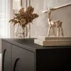 A close-up of a black dresser with decorative elements and accessories. Produktbild-Vorschau