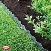 A close-up view of a garden border made of clear, wavy plastic, separating a lawn from a flower bed with dark soil and green plants. Produktbild-Vorschau