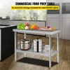 A stainless steel food preparation table with various fruits and vegetables on top, and appliances on the lower shelf. Voir les images du produit