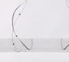 A close-up view of a white sheer curtain with a gray embroidered wavy bead pattern. Produktbild-Vorschau