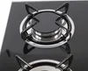 A close-up view of a black glass gas cooktop with two burners. Náhled obrázku produktu