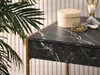 A close-up of a marble-topped desk with decorative items. Voir les images du produit