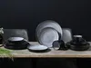 A set of stoneware dishes is arranged on a wooden table against a dark background. Náhľad obrázku produktu