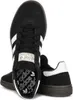 A pair of black Adidas Handball Spezial J IH8010 sneakers are shown against a white background. Voir les images du produit