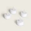 Four white LED tea lights are arranged on a light gray background. Anteprima dell’immagine prodotto