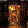 A miniature diorama of a magical library or study, designed to fit between books on a shelf. Voir les images du produit